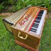 Kishori Aesthetic 42-Key Standing Harmonium offers a rich Indian voice with three sets of reeds and five stops. Its light brown finish adds a touch of elegance to any space.